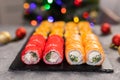 Sushi for Christmas New Year party, winter holiday food delivery menu. Sushi set asian food on background Christmas tree Royalty Free Stock Photo