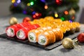 Sushi for Christmas New Year party, winter holiday food delivery menu. Sushi set asian food on background Christmas tree Royalty Free Stock Photo