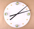 Sushi clock, time concept with caviar on a white plate Royalty Free Stock Photo