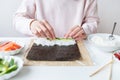 Sushi cooking process, girl makes sushi with different flavors