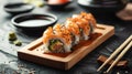 Sushi and fried garlic shrimps, prawn on a stone plate