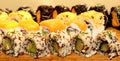 Sushi Fusion Rolls on wooden platter Royalty Free Stock Photo