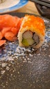 Sushi with ginger in plate, avocado, cucumbar, fish eggs, crabstick, nori, rice