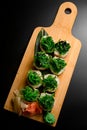 Sushi with green algae on a long green leaf on a wooden board Royalty Free Stock Photo