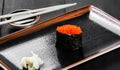 Sushi Gunkan maki with salmon caviar on dark wooden background. Japanese cuisine. Top view. Royalty Free Stock Photo