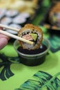 Sushi hot roll avocado salmon chopstick soy sauce