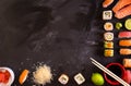 Sushi and ingredients on dark background Royalty Free Stock Photo