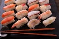 Sushi japanese food black slate platter wood chopsticks Royalty Free Stock Photo