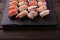 Sushi japanese food various selection black slate platter wood table