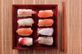 Sushi japanese food red tray chopsticks flat lay top view Royalty Free Stock Photo