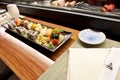 Sushi in Japanese Food Restaurant Ã¢â¬â Kitchen Serving Background, Plate with Soy Sauce, Row of Nigiri and Rolls with Wasabi