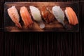 Sushi japanese food various wood tray flat top view dark background
