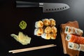 Sushi and Japanese knife on stone slate background Royalty Free Stock Photo