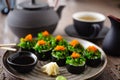 Sushi maki rolls with crab, seaweed salad and flying fish roe on a plate with chopsticks, soy sauce, wasabi and ginger Royalty Free Stock Photo