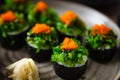 Sushi maki rolls with crab, seaweed salad and flying fish roe on a plate with chopsticks, soy sauce, wasabi and ginger Royalty Free Stock Photo