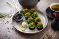 Sushi maki rolls with crab, seaweed salad and flying fish roe on a plate with chopsticks, soy sauce, wasabi and ginger Royalty Free Stock Photo