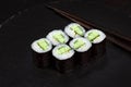 Sushi Maki rolls cucumber. Fresh hosomaki pieces with rice and nori. Close Up of delicious japanese food with sushi roll Royalty Free Stock Photo