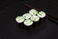 Sushi Maki rolls cucumber. Fresh hosomaki pieces with rice and nori. Close Up of delicious japanese food with sushi roll Royalty Free Stock Photo