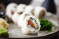 Sushi maki rolls Philadelphia with salmon, creamy cheese and avocado on a plate with chopsticks, soy sauce, wasabi and Royalty Free Stock Photo