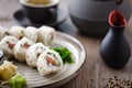 Sushi maki rolls Philadelphia with salmon, creamy cheese and avocado on a plate with chopsticks, soy sauce, wasabi and Royalty Free Stock Photo