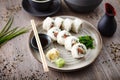 Sushi maki rolls Philadelphia with salmon, creamy cheese and avocado on a plate with chopsticks, soy sauce, wasabi and Royalty Free Stock Photo