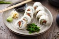 Sushi maki rolls Philadelphia with salmon, creamy cheese and avocado on a plate with chopsticks, soy sauce, wasabi and Royalty Free Stock Photo