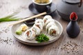 Sushi maki rolls Philadelphia with salmon, creamy cheese and avocado on a plate with chopsticks, soy sauce, wasabi and Royalty Free Stock Photo