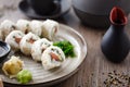 Sushi maki rolls Philadelphia with salmon, creamy cheese and avocado on a plate with chopsticks, soy sauce, wasabi and Royalty Free Stock Photo