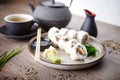 Sushi maki rolls Philadelphia with salmon, creamy cheese and avocado on a plate with chopsticks, soy sauce, wasabi and Royalty Free Stock Photo