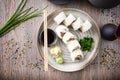 Sushi maki rolls Philadelphia with salmon, creamy cheese and avocado on a plate with chopsticks, soy sauce, wasabi and Royalty Free Stock Photo