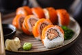 Sushi maki rolls with spicy crab, salmon, cucumber on a plate with chopsticks, soy sauce, wasabi and ginger. Japanese Royalty Free Stock Photo