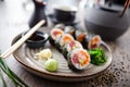 Sushi maki rolls with tuna, flying fish caviar, crab, avocado on a plate with chopsticks, soy sauce, wasabi and ginger Royalty Free Stock Photo