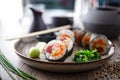 Sushi maki rolls with tuna, flying fish caviar, crab, avocado on a plate with chopsticks, soy sauce, wasabi and ginger Royalty Free Stock Photo