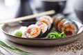 Sushi maki rolls with tuna, flying fish caviar, crab, avocado on a plate with chopsticks, soy sauce, wasabi and ginger Royalty Free Stock Photo