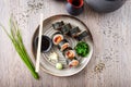 Sushi maki rolls with tuna, flying fish caviar, crab, avocado on a plate with chopsticks, soy sauce, wasabi and ginger Royalty Free Stock Photo