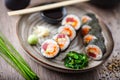 Sushi maki rolls with tuna, flying fish caviar, crab, avocado on a plate with chopsticks, soy sauce, wasabi and ginger Royalty Free Stock Photo