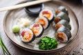 Sushi maki rolls with tuna, flying fish caviar, crab, avocado on a plate with chopsticks, soy sauce, wasabi and ginger Royalty Free Stock Photo