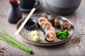 Sushi maki rolls with tuna, flying fish caviar, crab, avocado on a plate with chopsticks, soy sauce, wasabi and ginger Royalty Free Stock Photo