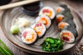 Sushi maki rolls with tuna, flying fish caviar, crab, avocado on a plate with chopsticks, soy sauce, wasabi and ginger Royalty Free Stock Photo