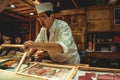 Sushi master chef preparing fresh sashimi for hungry customers in a luxury sushi restaurant in Tokyo Japan