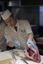 Sushi master slicing a tuna Royalty Free Stock Photo