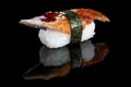 Sushi nigiri with eel on black background with reflection. Japan