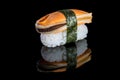 Sushi nigiri with mussel on black background with reflection. Ja