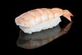 Sushi nigiri with shrimp on black background with reflection. Ja