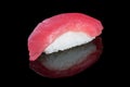 Sushi nigiri with tuna on black background with reflection. Japa