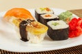 Sushi with omelet with eel and with salmon and rolls on bamboo mat close up. Royalty Free Stock Photo