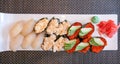 Sushi pieces with caviar, molusks on white plate with green wasabi and red colored ginger Royalty Free Stock Photo