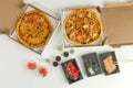 Sushi and pizza. Concept of business lunch, white background. Calorie food