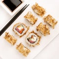 Sushi plate on white background, rolls set with tuna flakes on white background from above. Top view of traditional