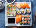 Sushi platter with different types of sushi rolls and sashimi on a white plate, in a top view Royalty Free Stock Photo